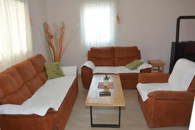 a living room with two couches and a coffee table at Vila Pelinovo in Kotor
