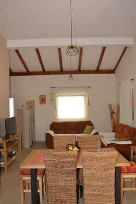 a living room with a couch and a table and chairs at Vila Pelinovo in Kotor