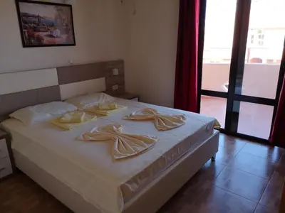 a bedroom with a bed with two dishes on it at Rooms Ibrocevic in Ulcinj