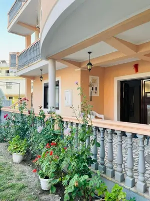 a porch of a house with potted plants at Rooms Ibrocevic in Ulcinj