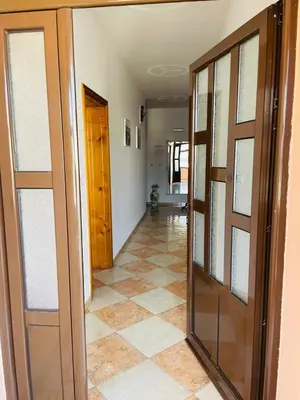 a hallway with doors and tiled floors at Rooms Ibrocevic in Ulcinj