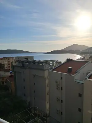 a view of a body of water from buildings at Apartman Verica in Rafailovici