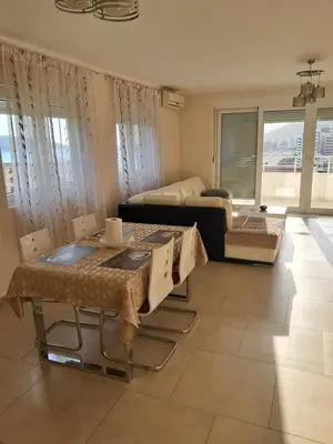 a living room with a couch and a table at Apartman Verica in Rafailovici