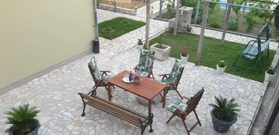 a patio with a table and chairs on a patio at Villa Katarina in Tivat
