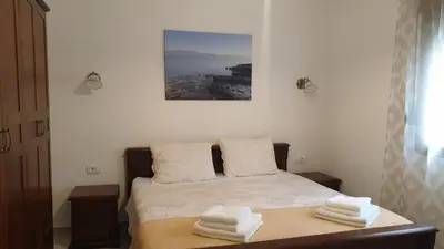 a bedroom with a bed with two towels on it at Villa Katarina in Tivat