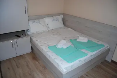 a bed with towels and towels on top of it at Kod Nade in Petrovac na Moru