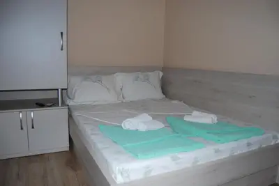 a white bed with towels on top of it at Kod Nade in Petrovac na Moru