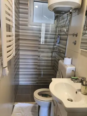 a bathroom with a toilet and a sink at Kod Nade in Petrovac na Moru