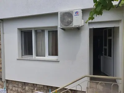 a house with a fan on the side of it at Kod Nade in Petrovac na Moru