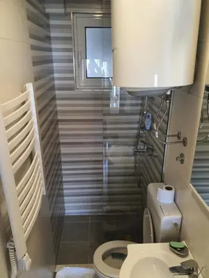a small bathroom with a toilet and a sink at Kod Nade in Petrovac na Moru