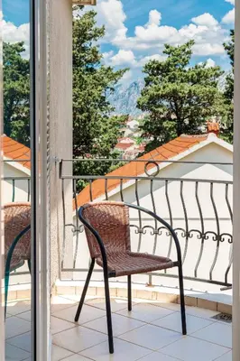 a pair of chairs on a balcony with a view at Antonella in Kotor
