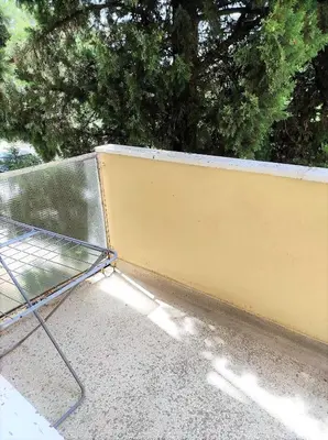 a bench sitting in front of a wall at Stan u centru in Podgorica