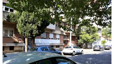 a group of cars parked in front of a building at Stan u centru in Podgorica