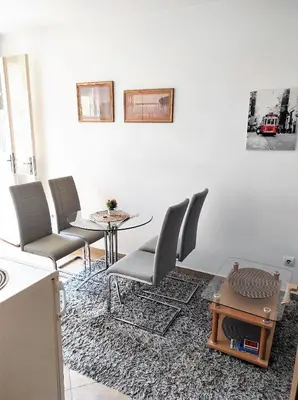 a dining room with a table and chairs and a table and a tableablish at Stan u centru in Podgorica