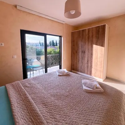 a bedroom with a bed with two towels on it at Apartments Aerodrom in Podgorica