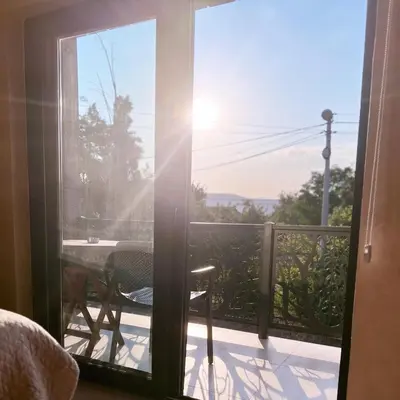 a view from the bedroom door of a balcony with a table at Apartments Aerodrom in Podgorica