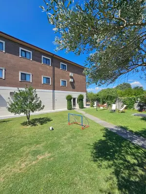 a playground in a yard in front of a building at Apartments Aerodrom in Podgorica