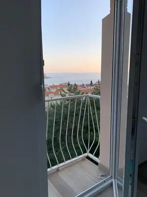 a room with a balcony with a view of the ocean at Seahaven in Petrovac na Moru