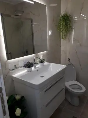 a bathroom with a sink and a toilet and a mirror at Seahaven in Petrovac na Moru