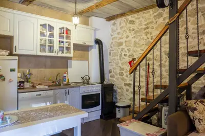 a kitchen with white cabinets and a staircase in it at Rijeka Crnojevića, Lidija Apartment in Rijeka Crnojevića