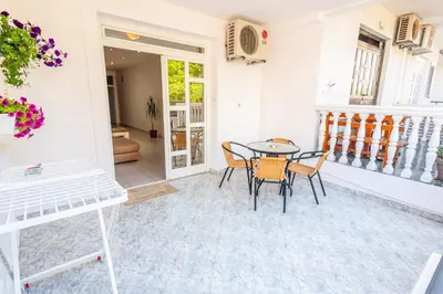 a dining room with a table and chairs at Apartments Adriatic in Sveti Stefan