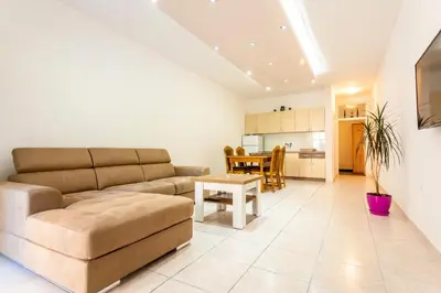 a living room with a couch and a table at Apartments Adriatic in Sveti Stefan