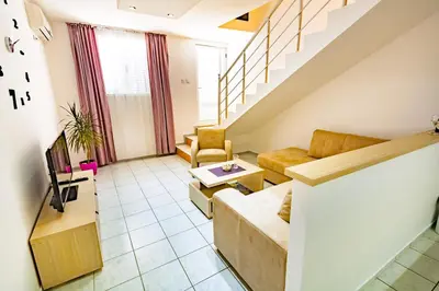 a living room with a couch and a table at Apartments Adriatic in Sveti Stefan