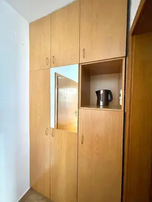 a cupboard with a pot sitting on top of it at Vila L Budva in Budva