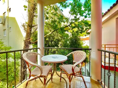 a balcony with a table and two chairs at Vila L Budva in Budva