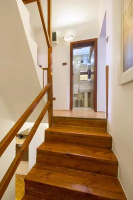 a staircase in a house with wooden floors at Apartment Kovacevic Old Town in Budva