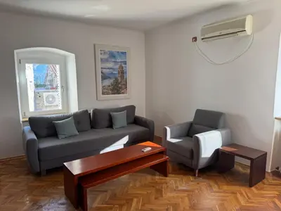 a living room with a couch and a chair at Apartment Kovacevic Old Town in Budva