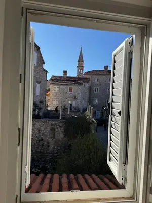 an open window with a view of a castle at Apartment Kovacevic Old Town in Budva