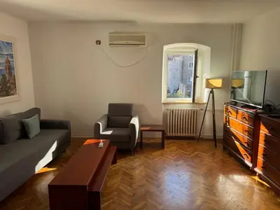 a living room with a couch and a tv at Apartment Kovacevic Old Town in Budva