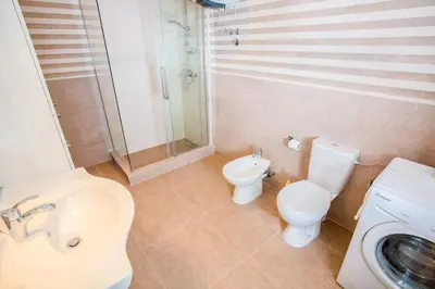 a bathroom with a sink and a toilet and a shower at Luxury House Petrovic - Vranjina Skadar Lake in Podgorica