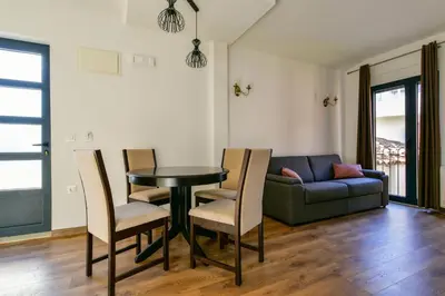 a living room with a table and chairs and a couch at Apartmani Djurovic in Ulcinj