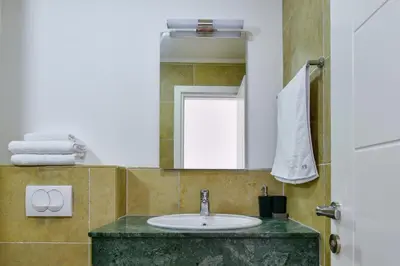 a bathroom with a sink and a mirror at Apartmani Djurovic in Ulcinj