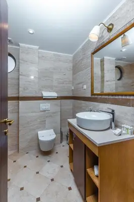 a bathroom with a sink and a toilet and a mirror at Hotel Plaza Lucice in Petrovac na Moru