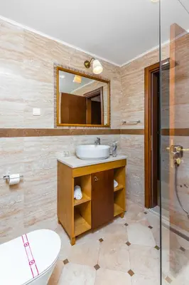 a bathroom with a sink and a mirror at Hotel Plaza Lucice in Petrovac na Moru