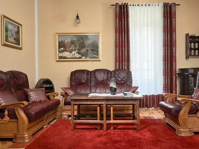 a living room with leather couches and a table at Apartment Palata Bizanti in Kotor