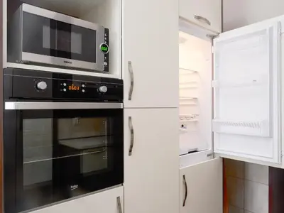 a kitchen with a microwave and a refrigerator at Apartment Palata Bizanti in Kotor