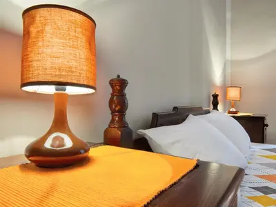 a lamp sitting on a table next to a bed at Apartment Palata Bizanti in Kotor