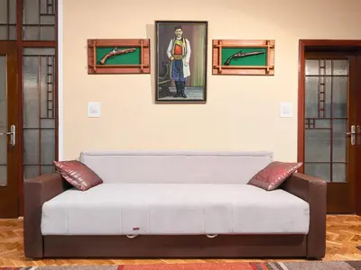 a couch in a living room with a picture on the wall at Apartment Palata Bizanti in Kotor