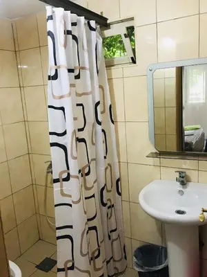 a bathroom with a sink and a shower curtain at Flamingo Cottage in Ulcinj