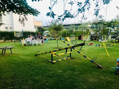 a park with a playground with people playing at Flamingo Cottage in Ulcinj