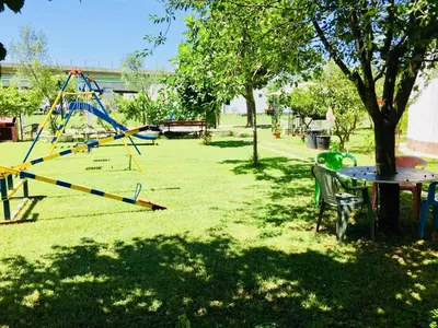 a park with a swing set and a table at Flamingo Cottage in Ulcinj