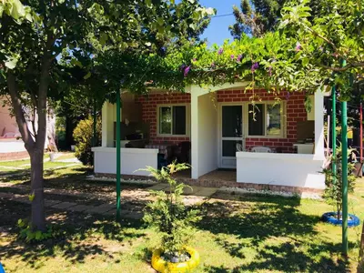 a house with a garden in front of it at Flamingo Cottage in Ulcinj
