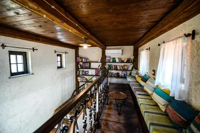 a room with bookshelves and benches in a library at Stara Čaršija Hotel & SPA in Bar