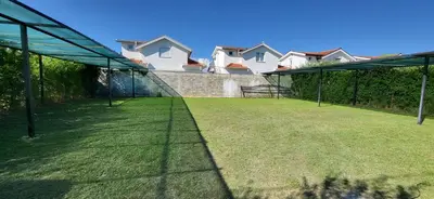 a tennis court in a yard with houses in the background at Apartmani Vila Milaris in Ulcinj