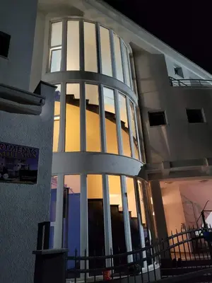 a building with a large window on the side of it at Apartmani Vila Milaris in Ulcinj