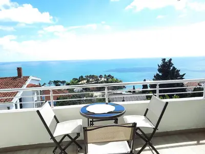 a balcony with a table and chairs and the ocean at Studio Apartments Jupo in Ulcinj